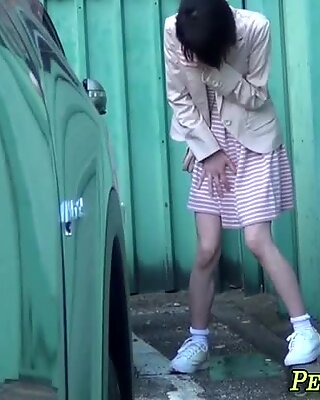 Asian girl pisses outside and fingers