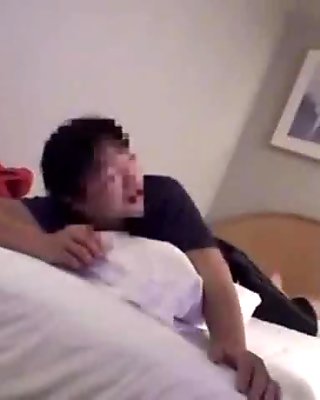 Japanese chick with short hair poses and sucks in a hotel